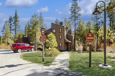 a street light and signs in front of a building at Silver Strike Summit in Truckee