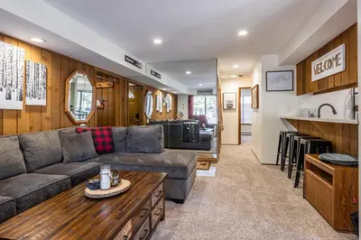 a living room with a couch and a table at Ground Level, Sunshine Village #171- 2 bed/2 bath, Sleeps 6. Steps from Free Town Shuttle in Mammoth Lakes