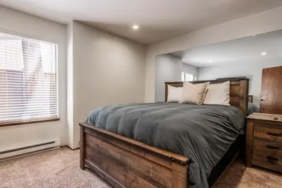 a bedroom with a large bed and a window at Ground Level, Sunshine Village #171- 2 bed/2 bath, Sleeps 6. Steps from Free Town Shuttle in Mammoth Lakes