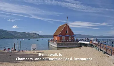 a building on a dock next to a body of water at WSH1030 - Camp Westwater home in Tahoma