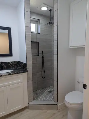 a shower with a glass door in a bathroom at Welcome to Lilith's House! in Clovis