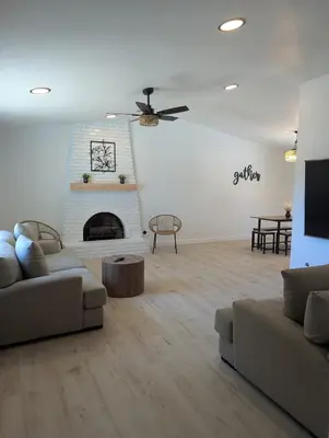 a living room with a couch and a fireplace at Welcome to Lilith's House! in Clovis