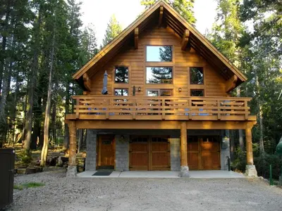 a log home with a large deck on top at Updated Winter Getaway Great for Skiing in Soda Springs, California in Soda Springs
