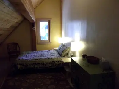 a bedroom with a bed and a desk and a window at Updated Winter Getaway Great for Skiing in Soda Springs, California in Soda Springs