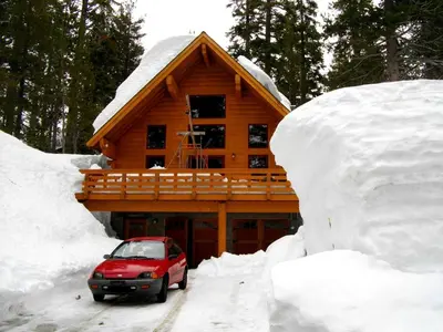 a car parked in the snow in front of a log cabin at Updated Winter Getaway Great for Skiing in Soda Springs, California in Soda Springs