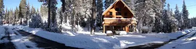 a log cabin in the snow in a forest at Updated Winter Getaway Great for Skiing in Soda Springs, California in Soda Springs
