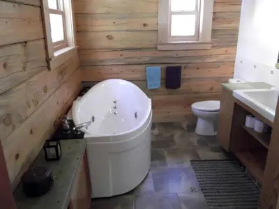 a bathroom with a white tub and a toilet at Updated Winter Getaway Great for Skiing in Soda Springs, California in Soda Springs