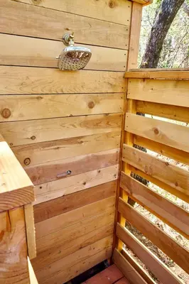 a wooden wall of a sauna with a sink at Safari Tents for Romantic Escapes in California's El Dorado County in Pilot Hill