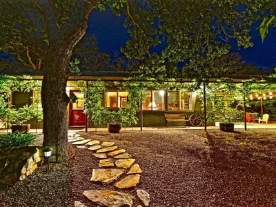 a house with a tree in front of it at Quiet Cottage Rental for Two in Horse Country near Yosemite National Park Gateway, California in Catheys Valley