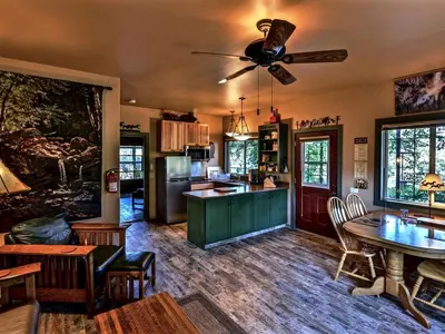 a kitchen and living room with a ceiling fan at Quiet Cottage Rental for Two in Horse Country near Yosemite National Park Gateway, California in Catheys Valley