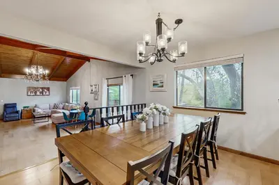 a dining room with a large wooden table and chairs at Harmony Haven in Groveland