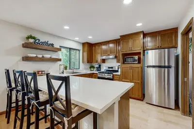 a kitchen with a white counter top and a refrigerator at Harmony Haven in Groveland