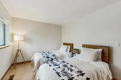 two beds in a room with white walls at Harmony Haven in Groveland
