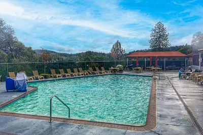 a large swimming pool with chairs and tables at Harmony Haven in Groveland