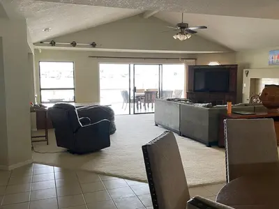 a living room with a couch and a kitchen at Discovery Bay Home on fast water - 2,400Sq ft in Discovery Bay