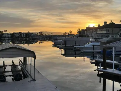 a group of boats parked in a marina at sunset at Discovery Bay Home on fast water - 2,400Sq ft in Discovery Bay