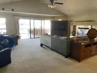 a living room with a couch and a tv at Discovery Bay Home on fast water - 2,400Sq ft in Discovery Bay