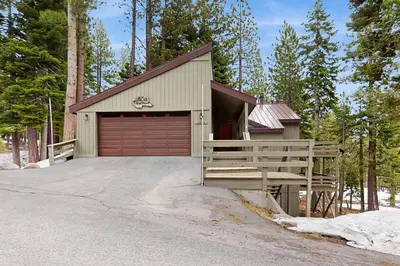 a garage with a red garage door and a driveway at Peace and Pines at Upper Ward Creek in Tahoe City