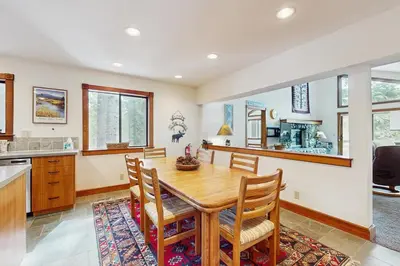 a kitchen and dining room with a wooden table and chairs at Peace and Pines at Upper Ward Creek in Tahoe City
