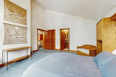 a bedroom with a large bed and a table and chair at Peace and Pines at Upper Ward Creek in Tahoe City