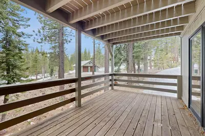 a large wooden porch with a view of the woods at Peace and Pines at Upper Ward Creek in Tahoe City