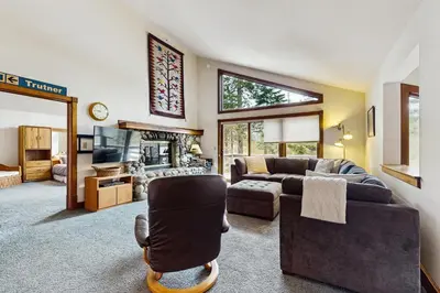 a living room with a couch and a tv at Peace and Pines at Upper Ward Creek in Tahoe City