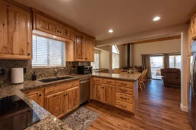 a kitchen with wooden cabinets and a counter top at Charming and Relaxing Getaway with Great Views in Shaver Lake