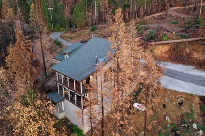 an aerial view of a house in the woods at Charming and Relaxing Getaway with Great Views in Shaver Lake