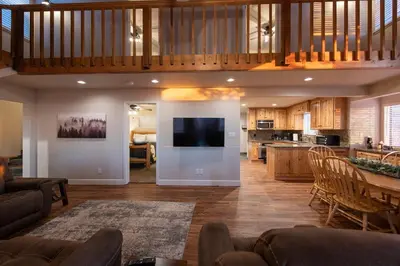 a living room and kitchen with a couch and a table at Charming and Relaxing Getaway with Great Views in Shaver Lake