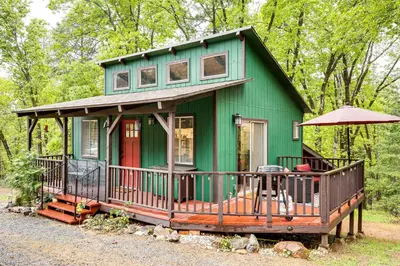 a green tiny house with a red door at Hidden Valley Retreat - Outdoorsy West Point Gem in West Point