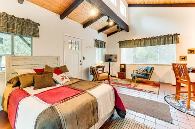 a bedroom with a large bed and a living room at Hidden Valley Retreat - Outdoorsy West Point Gem in West Point