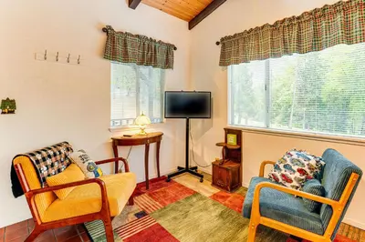 a living room with two chairs and a tv at Hidden Valley Retreat - Outdoorsy West Point Gem in West Point