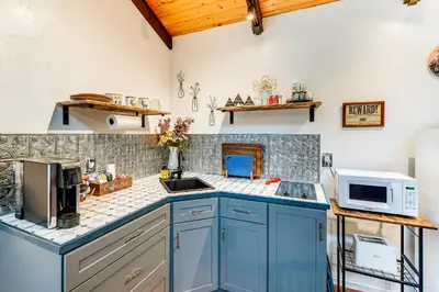 a kitchen with blue cabinets and a microwave at Hidden Valley Retreat - Outdoorsy West Point Gem in West Point