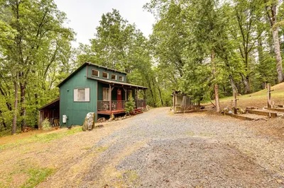 a green house on the side of a dirt road at Hidden Valley Retreat - Outdoorsy West Point Gem in West Point