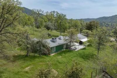 an aerial view of a house in a field at Green Meadows at Sky Ranch, 13 miles from Yosemite in Oakhurst
