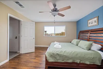 a bedroom with a bed with a ceiling fan at Sunset Lookout Mountain villa, Meadows, Gazebo in Coarsegold