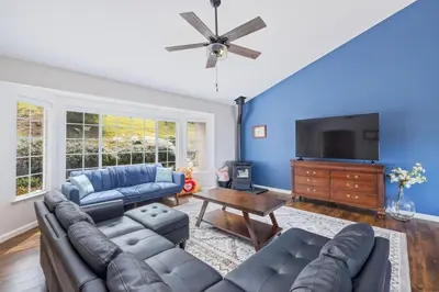 a living room with a couch and a tv at Sunset Lookout Mountain villa, Meadows, Gazebo in Coarsegold