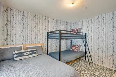 a bedroom with a bed and a bunk bed at Backyard Forest Retreat in South Lake Tahoe