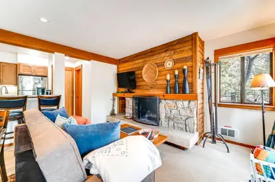 a living room with a couch and a fireplace at Hike, Sled and Ski! Cozy Tahoe City Condo with Hot Tub in Tahoe City