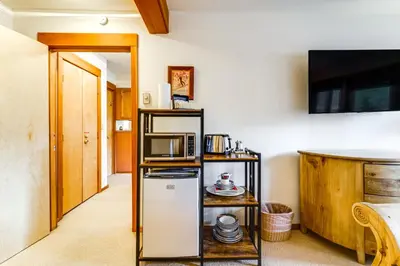a kitchen with a refrigerator and a microwave at Hike, Sled and Ski! Cozy Tahoe City Condo with Hot Tub in Tahoe City