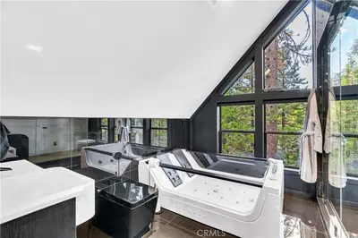 a bathroom with two sinks and a large window at Modern Mountain Luxury Soak, Stay, & Be Spoiled in Shaver Lake