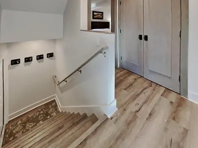 a hallway with white walls and wooden floors and a staircase at 1849 Condos 642 home in Mammoth Lakes