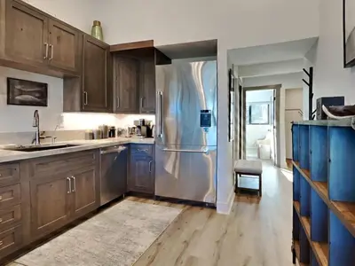 a kitchen with wooden cabinets and a stainless steel refrigerator at 1849 Condos 642 home in Mammoth Lakes