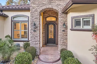 a brick house with a door with an archway at Beautiful Granite Bay Home near Folsom Lake in Granite Bay