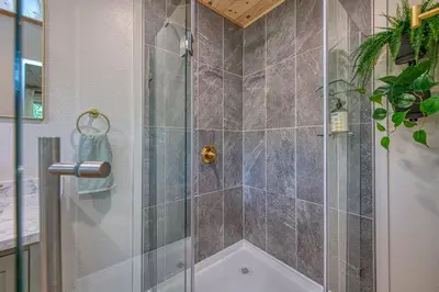 a shower with a glass door in a bathroom at The Mountains are Calling - Private, Guesthouse Retreat near Yosemite in Ahwahnee