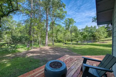 a porch with a bench and a chair on a deck at The Mountains are Calling - Private, Guesthouse Retreat near Yosemite in Ahwahnee