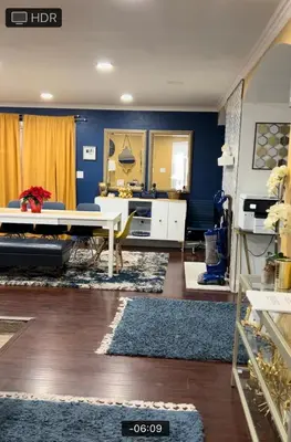 a living room with a table and a blue wall at Memorable Moment at Placid Blue with Pool & Hot Tub in Sacramento