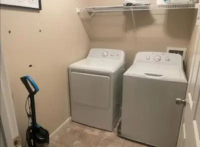 a small laundry room with a washer and dryer at Spacious 4 bedroom house! in Stockton