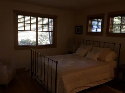 a bedroom with a bed and two windows at Modern Woodland Cabin Getaway with a Fireplace in Truckee, California in Truckee