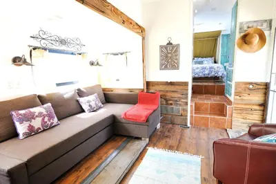 a living room with a couch and a bed at Rustic Trailer Rental on the Shores of Bridgeport Reservoir, California in Bridgeport